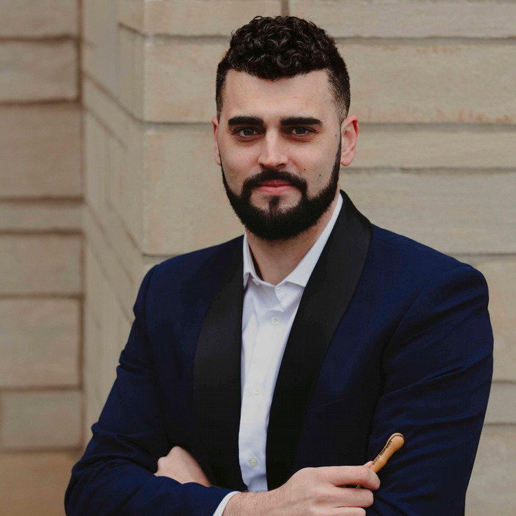 Man smiling with arms crossed